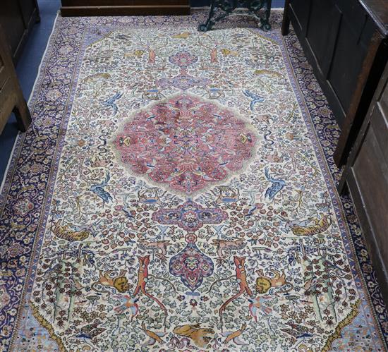 A Persian Tree of life ivory ground carpet W.275 x 180cm